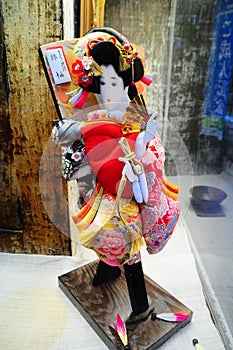 A Japanese doll in the window